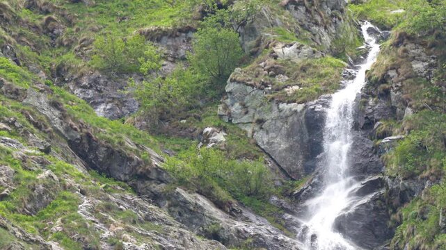 Waterfall Cascading Down Rocky Cliff Near Lago della Rovina, Italy