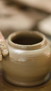 Close Up of Artisan Hands Shaping Clay Pot on Pottery Wheel