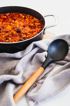 homemade vegetarian tempeh kidney bean chilli with corn in cooking pot
