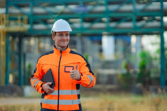 Confident industrial engineer giving a thumbs up after completing a successful refinery inspection. Engineering success, workplace safety, maintenance completion, industrial confidence,