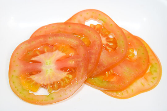 Fresh ripe red tomato slices isolated on white background photo