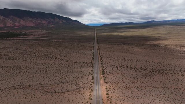 High drone of endless Recta del Tin Tin highway through desert valley, aerial