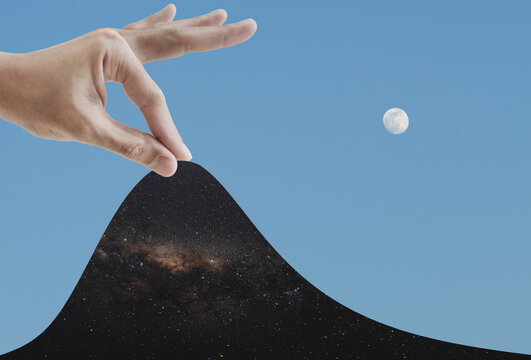 Digital collage, hand opening blue sky to the night sky full of stars