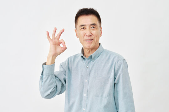 白背景でOKサインの男性