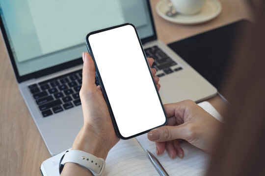 Mockup, business woman using smartphone with blank screen during working at office, closeup.