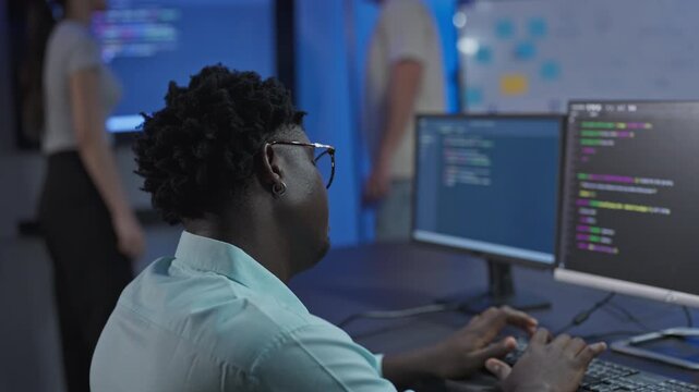 African male developer focuses on advanced debugging and troubleshooting complex code issues, utilizing syntax analysis for issue resolution and problem investigation.