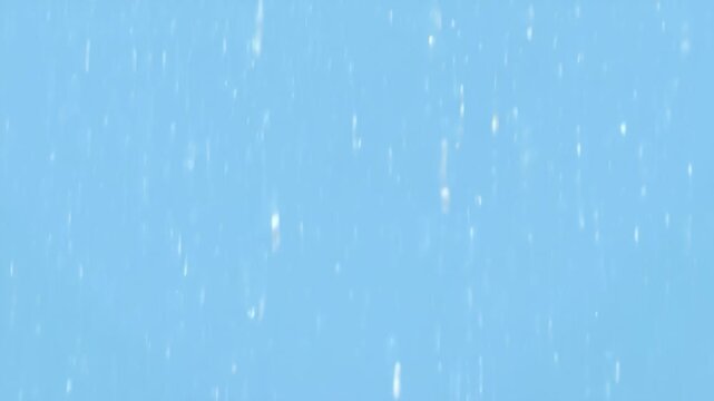 Snowflakes falling on a blue background, raindrops on a blue background
