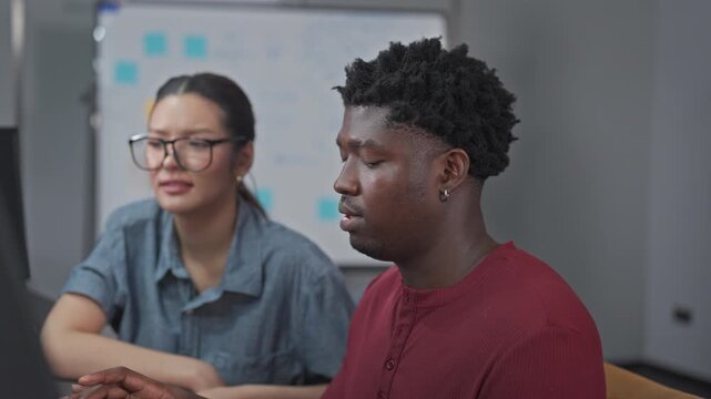 Female and male developers engage in peer-level discussion, sharing insights and knowledge through collaborative dialogue and technical exchange.