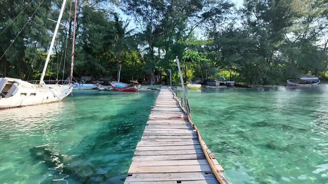 Forward Moving Shot Along Wooden Pier Over Crystal Clear Water in Karimunjawa, Indonesia