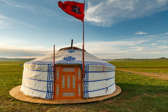 Traditional nomadic ger home with flag on the grass steppe of Mongolia