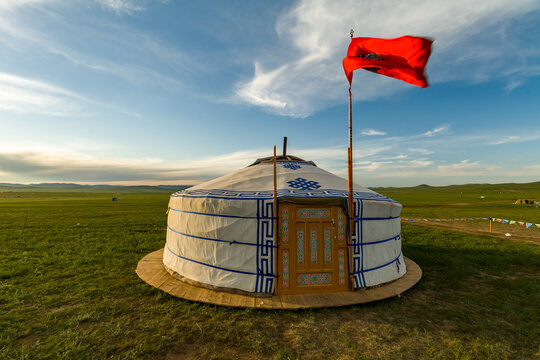 Traditional nomadic ger home with flag on the grass steppe of Mongolia