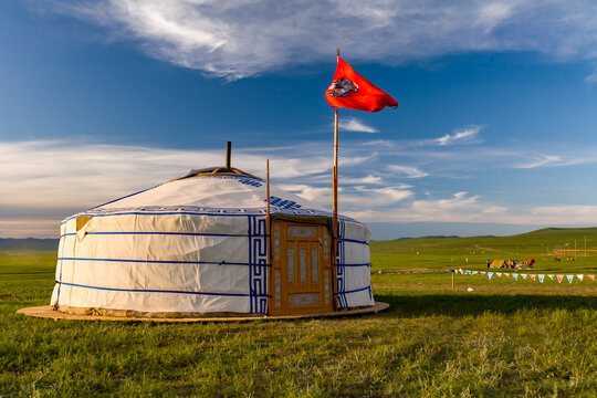 Traditional nomadic ger home with flag on the grass steppe of Mongolia
