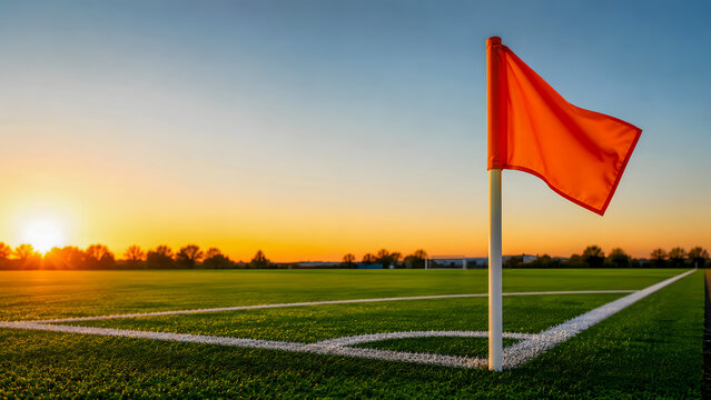 Corner flag on soccer field at sunset with clear sky  