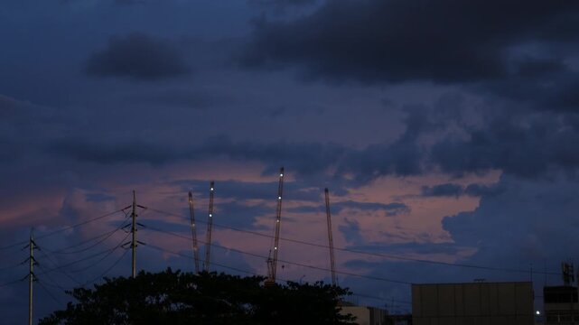 Tower Cranes Silhouette Construction Site Dramatic Dusk Sky Clouds Powerline Urban Skyline Twilight Footage Time Lapse City Development