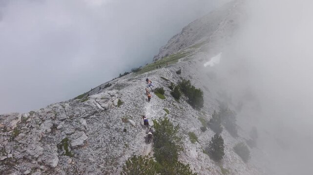 Aerial View of Pack Mules Ascending Rocky Ridge on Mount Olympus in Heavy Fog