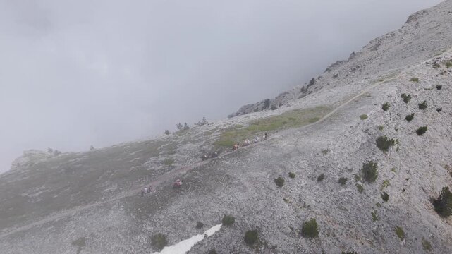 Aerial View of Pack Mules Ascending Rocky Ridge on Mount Olympus in Heavy Fog