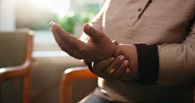 Arthritis, old woman or hands in house with stretch, joint pain or discomfort in wrist movement. Retirement, tendinitis and senior person with ache, chronic condition and sore muscle in living room.