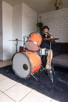 A jazz drummer practices at home