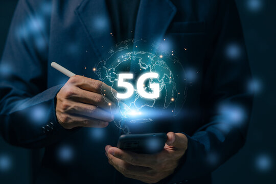 Business professional using smartphone with glowing 5G hologram representing next generation wireless communication, mobile connectivity, digital transformation and global network technology.