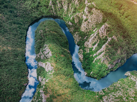 Aerial view of a winding Uvac river meandering through a lush green canyon. Nature concept.