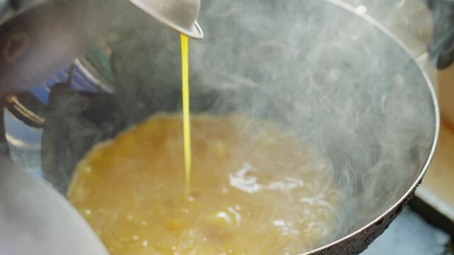 Pour the orange egg liquid into the iron pan and quickly stir-fry it into egg cubes