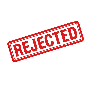 Bright red rejected rubber stamp for document feedback on transparent surface.