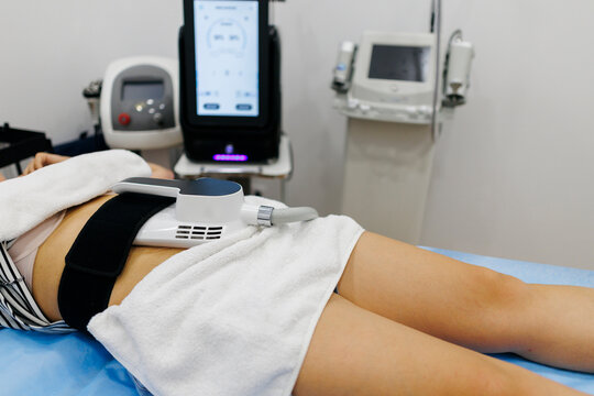 Woman undergoing cryolipolysis treatment for body contouring