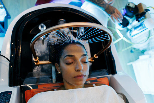 Woman enjoying modern scalp therapy hair treatment