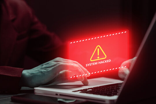 Cybersecurity warning with hacked system alert on a laptop, illustrating cyber attack, online threat, malware protection, digital risk, network security and information safety.