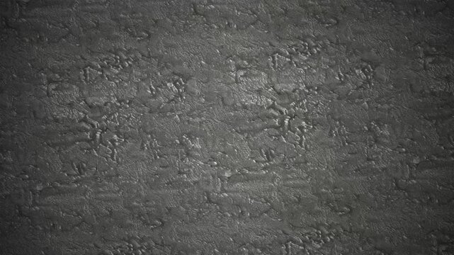 Dark grey stucco wall texture with subtle light shimmering motion