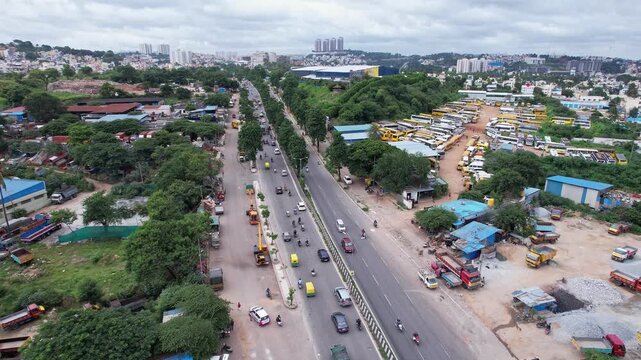 Aerial panoramic view showing busy regular traffic on lush bangalore mysore highway during winter
