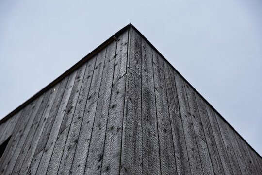 Low-angle view of a building clad in black charred timber using the traditional Shou Sugi Ban (Yakisugi) wood preservation technique, with minimalist architecture and copy space