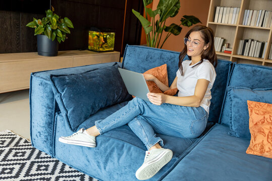 Young woman having a video call and looking joyful