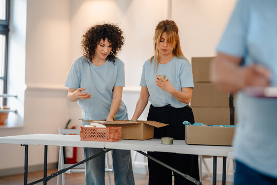 Volunteers packing donation boxes for community charity