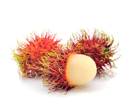 Fresh ripe rambutan tropical fruit isolated on white background, group of exotic red hairy fruits with one peeled showing white succulent flesh