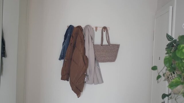 Coats and bags hanging on a wall in a home