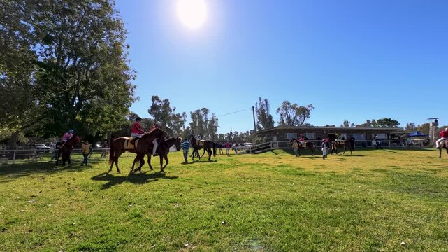 Jockeys Riding Thoroughbred Horses in Mounting Yard at Country Racecourse