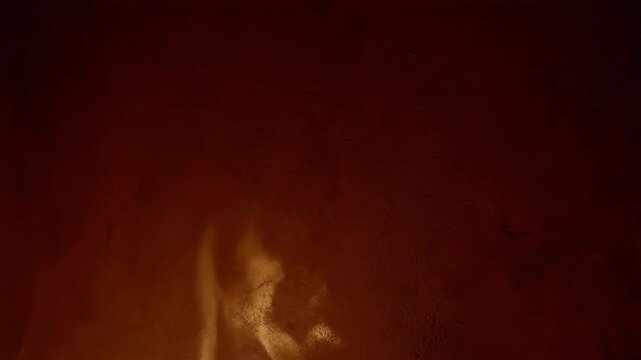 Abstract cinematic close-up of dark maroon textured wall background illuminated by a dramatic fiery orange glow, creating a moody and dramatic background texture.
