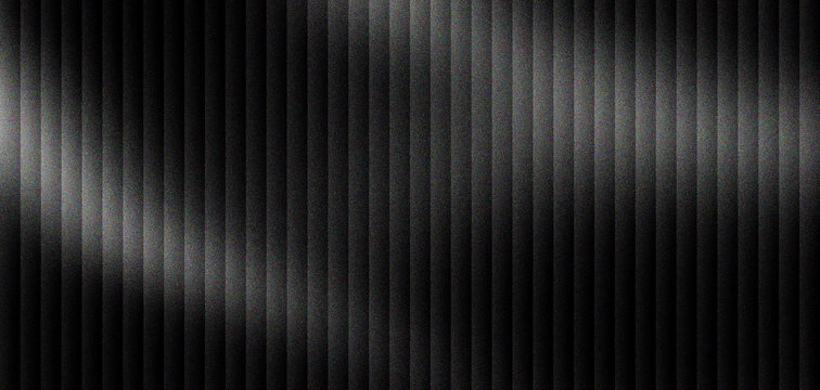 Brushed black metal texture with vertical stripes. Dark industrial aluminum background with metallic light reflections. Sleek carbon steel surface for modern technology and automotive design.