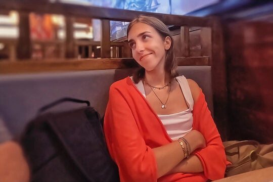 A beautiful young woman in a red jacket