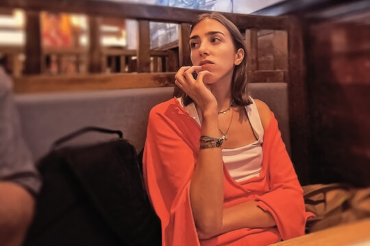 A beautiful young woman in a red jacket