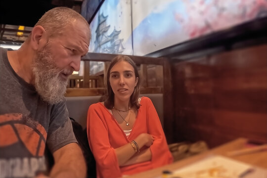 Mature man and woman in a cafe.