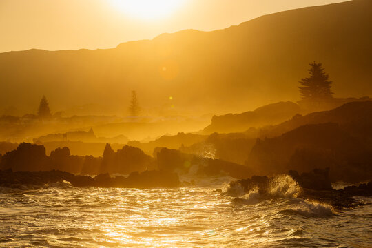 beautiful rugged rocky coastline of Kammabaai Beach, Hermanus, South Africa at sunset and dusk