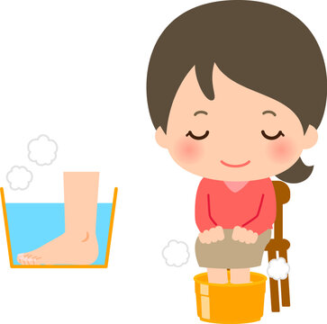 家庭で足湯をする若い女性