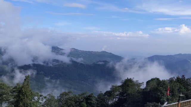 A breathtaking 4K landscape featuring rolling clouds drifting over lush green mountain hills under a beautiful blue sky. Perfect for travel, nature, environment, scenic, and outdoor projects.
