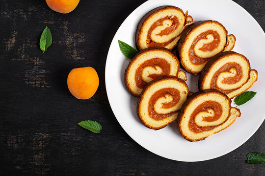Traditional Swiss Roll with Apricot Filling and Fresh Apricots. Top view