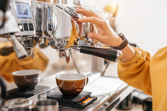 Barista making coffee with coffee machine