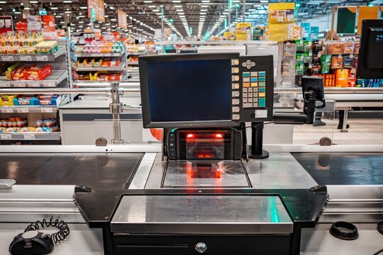 Modern supermarket checkout counter with barcode scanner and digital screen display checkout supermarket