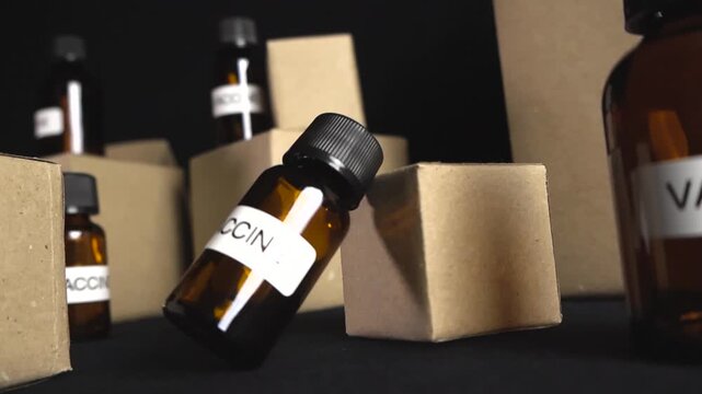 Brown glass vials labeled vaccine are shown with cardboard boxes, representing the distribution and logistics of immunization programs against diseases like coronavirus, flu, and other pandemics