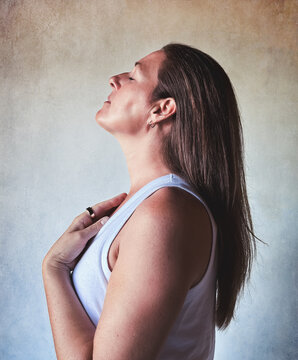 Serene woman breathing deeply with eyes closed